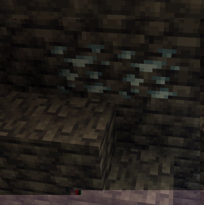 Deepslate tin ore in a cave wall